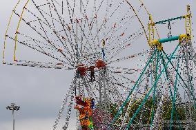 A Labourer Works on A Giant Ferris Wheel - India