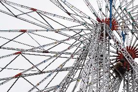 A Labourer Works on A Giant Ferris Wheel - India