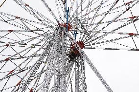 A Labourer Works on A Giant Ferris Wheel - India