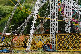 A Labourer Works on A Giant Ferris Wheel - India