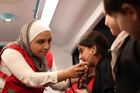 Syrian Red Crescent Volunteers Training Children In First Aid At Damascus International Fair