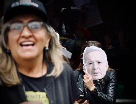 Supporters Hold Masks of Former President Alvaro Uribe During Trial in Bogota