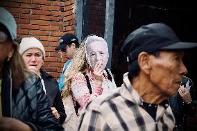 Supporters Hold Masks of Former President Alvaro Uribe During Trial in Bogota