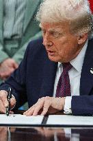 DC: President Trump Signs a Presidential Memorandum in Oval Office