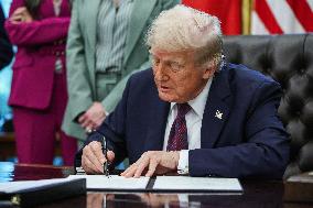 DC: President Trump Signs a Presidential Memorandum in Oval Office