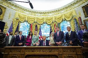DC: President Trump Signs a Presidential Memorandum in Oval Office
