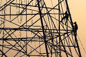 Workers Are Installing a High-Voltage Electricity Pylon - India