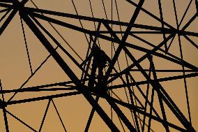Workers Are Installing a High-Voltage Electricity Pylon - India