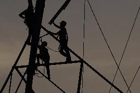 Workers Are Installing a High-Voltage Electricity Pylon - India