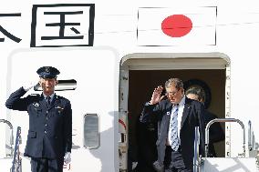 Japan PM returns home