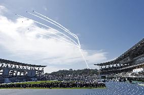 Blue Impulse aerobatic team flies over sports festival venue