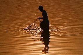 A Man Fishes in The Shallow Waters - India