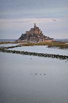 Mont-Saint-Michel and its bay in northwestern France. FC
