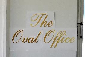 The Oval Office with a new sign up front - Washington