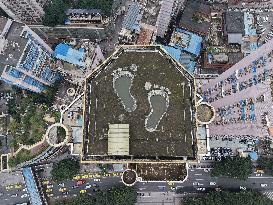 Giant Footprints on Building Rooftop in Chongqing
