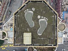 Giant Footprints on Building Rooftop in Chongqing