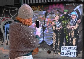 Provocative Wall Art Depicting Thunberg and Albanese with a Hamas Militant - Milan