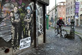 Provocative Wall Art Depicting Thunberg and Albanese with a Hamas Militant - Milan