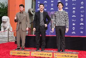 Jonas Brothers Hand And Footprint In Cement Ceremony - LA