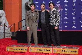Jonas Brothers Hand And Footprint In Cement Ceremony - LA