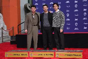 Jonas Brothers Hand And Footprint In Cement Ceremony - LA