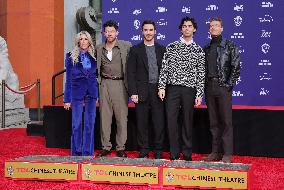Jonas Brothers Hand And Footprint In Cement Ceremony - LA