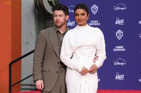 Jonas Brothers Hand And Footprint In Cement Ceremony - LA