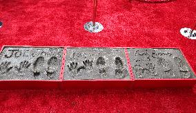 Jonas Brothers Hand And Footprint In Cement Ceremony - LA
