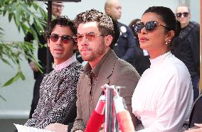 Jonas Brothers Hand And Footprint In Cement Ceremony - LA