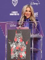 Jonas Brothers Hand And Footprint In Cement Ceremony - LA