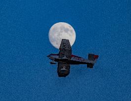 Flying Club Plane Passes Full Moon