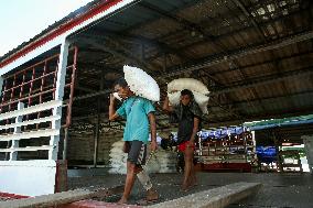 Workers Carry Bags of Rice - Myanmar