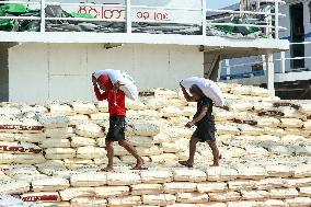 Workers Carry Bags of Rice - Myanmar