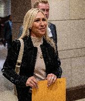 Representative Marjorie Taylor Greene walks out  after  the  classified briefing