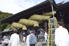 Giant "shimenawa" straw rope replacement at shrine