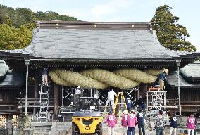 Giant "shimenawa" straw rope replacement at shrine