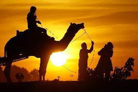 Tourists Enjoy a Camel Safari - India