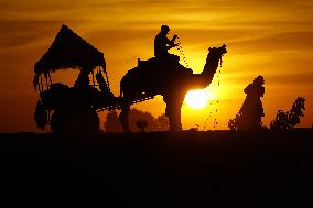 Tourists Enjoy a Camel Safari - India