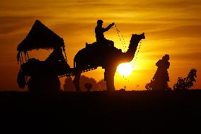 Tourists Enjoy a Camel Safari - India