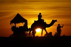 Tourists Enjoy a Camel Safari - India