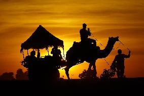Tourists Enjoy a Camel Safari - India