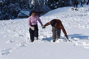People Enjoy The Season's First Snowfall In Kashmir