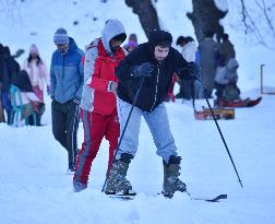 People Enjoy The Season's First Snowfall In Kashmir