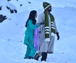 People Enjoy The Season's First Snowfall In Kashmir