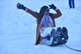 People Enjoy The Season's First Snowfall In Kashmir