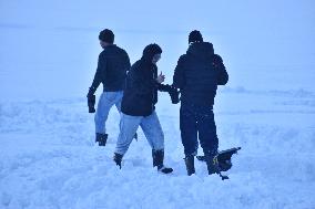 People Enjoy The Season's First Snowfall In Kashmir