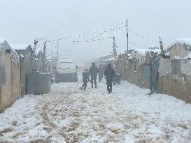 Snowstorms hit Syrian refugee camps.