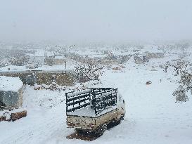 Snowstorms hit Syrian refugee camps.