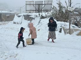 Snowstorms hit Syrian refugee camps.