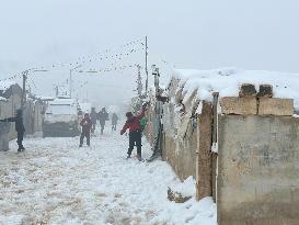 Snowstorms hit Syrian refugee camps.